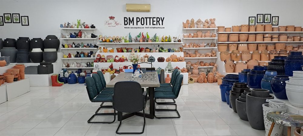 Showroom meeting area with pots and figures on display